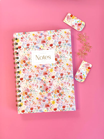 Floral notebook with 'Notes' label on a pink background