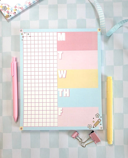 Pastel-colored planner with grid and notes on a checkered background