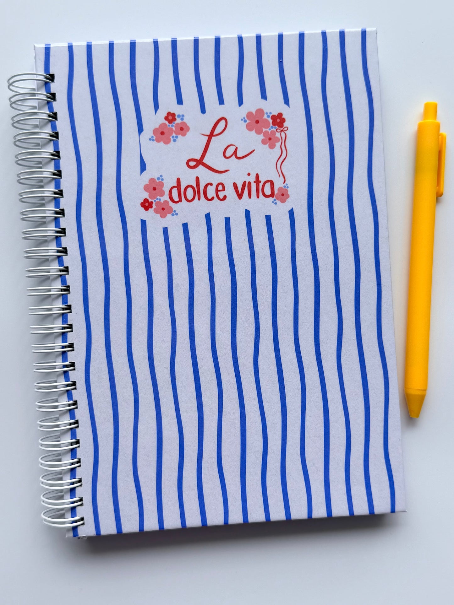 Blue Italian inspired lined notebook with white spiral coils. 